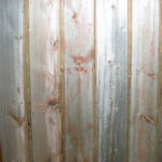 Close up of faded red wood reclaimed wood paneling