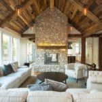 Living room with fireplace mantel and hand hewn timbers