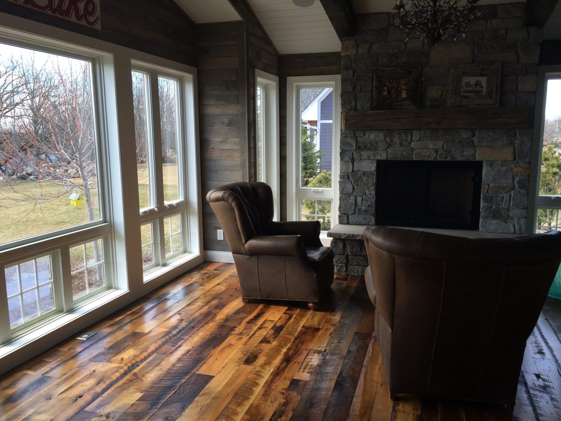 Living area with mixed reclaimed wood flooring