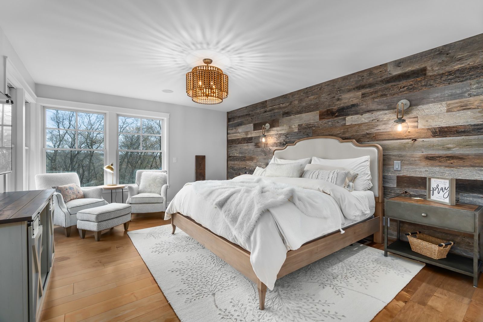 a bedroom with reclaimed barn wood behind it on an accent wall