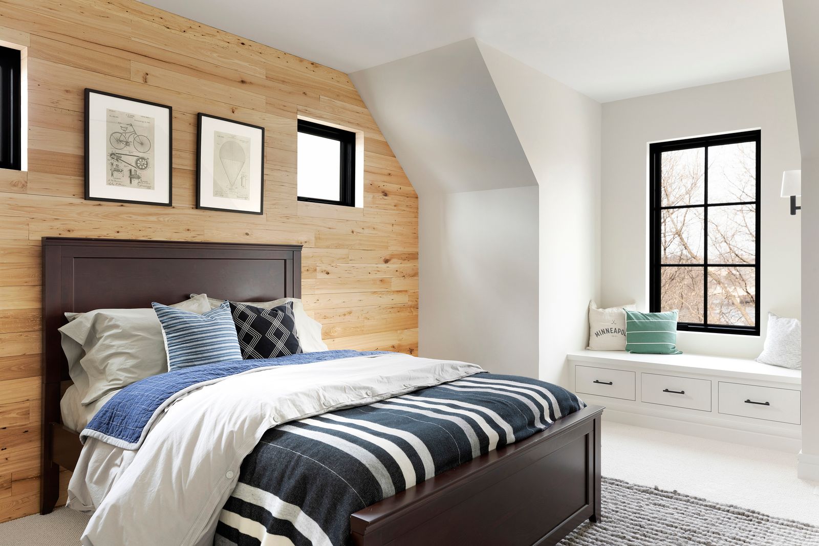 a bedroom with reclaimed wood paneling behind the bed