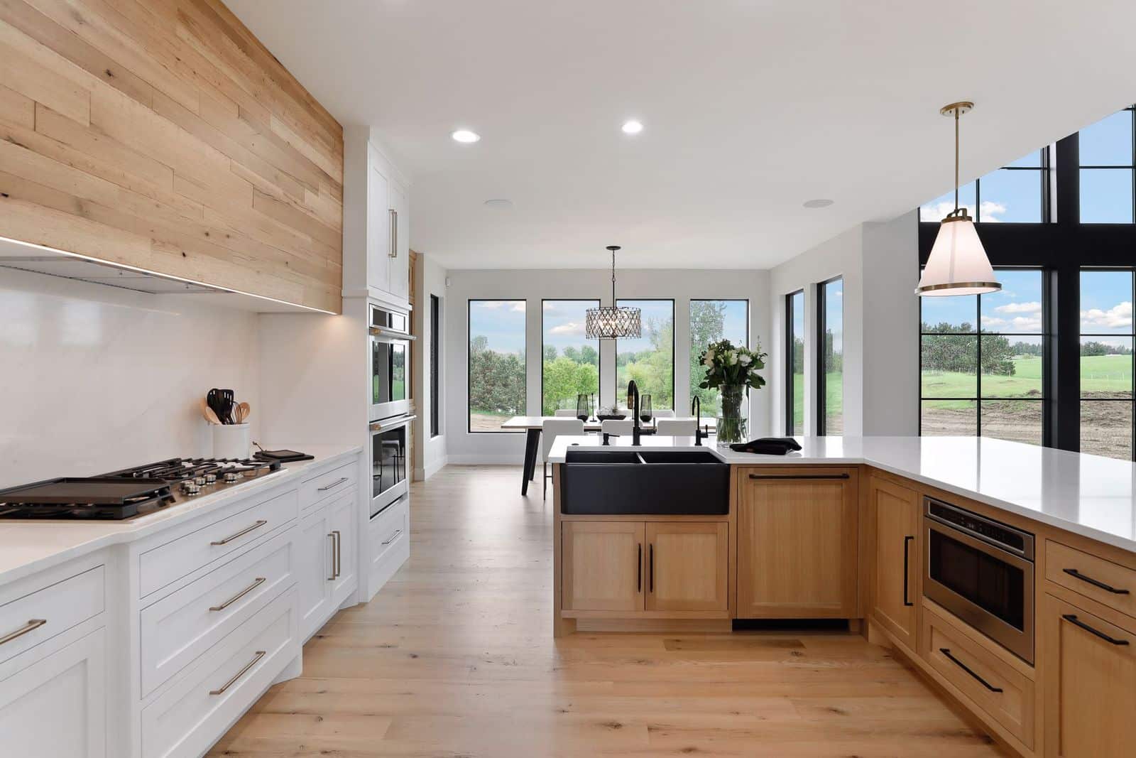 a beautiful modern kitchen with reclaimed barn wood paneling above the range