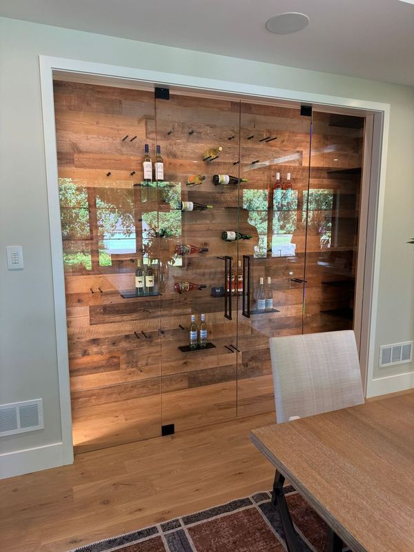 a wine rack just off of the dining room with reclaimed wood paneling 