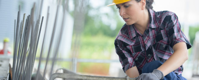 woman working on metal structure