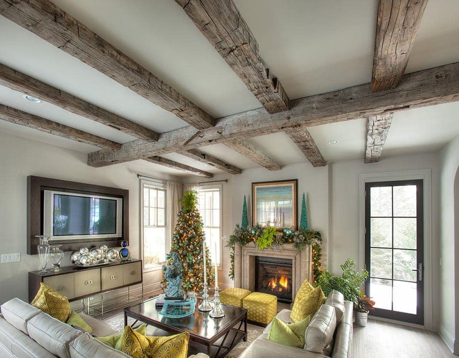 living room decorated for christmas with hand hewn reclaimed wood beams
