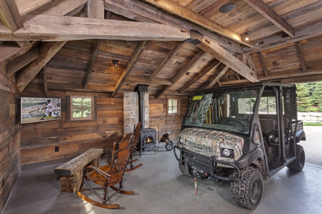 utv parked in a garage made of reclaimed wood beams