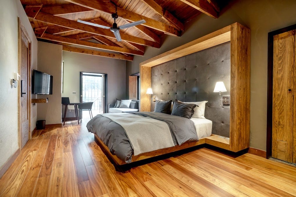 reclaimed wood bedframe inside large bedroom