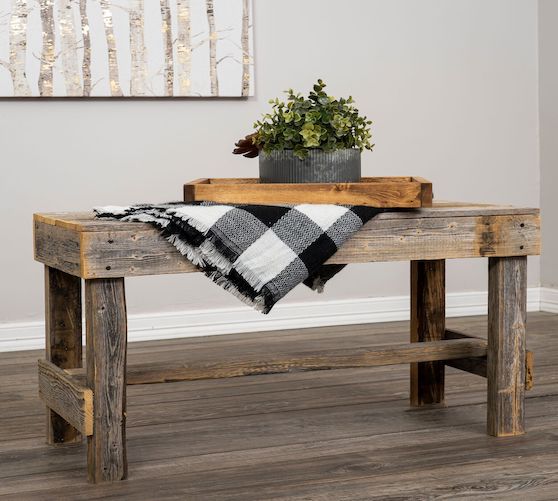 reclaimed wooden bench with blanket and plant decoration