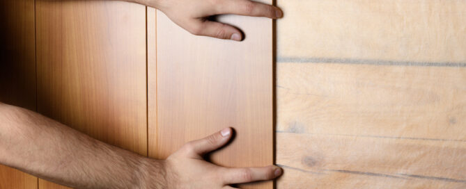 man working to install paneling on wall