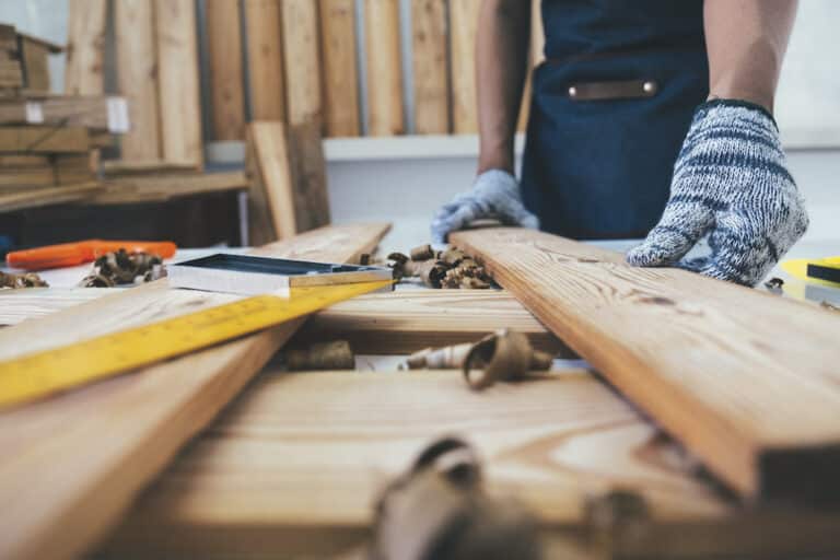 Man working on reclaimed wood floating shelves