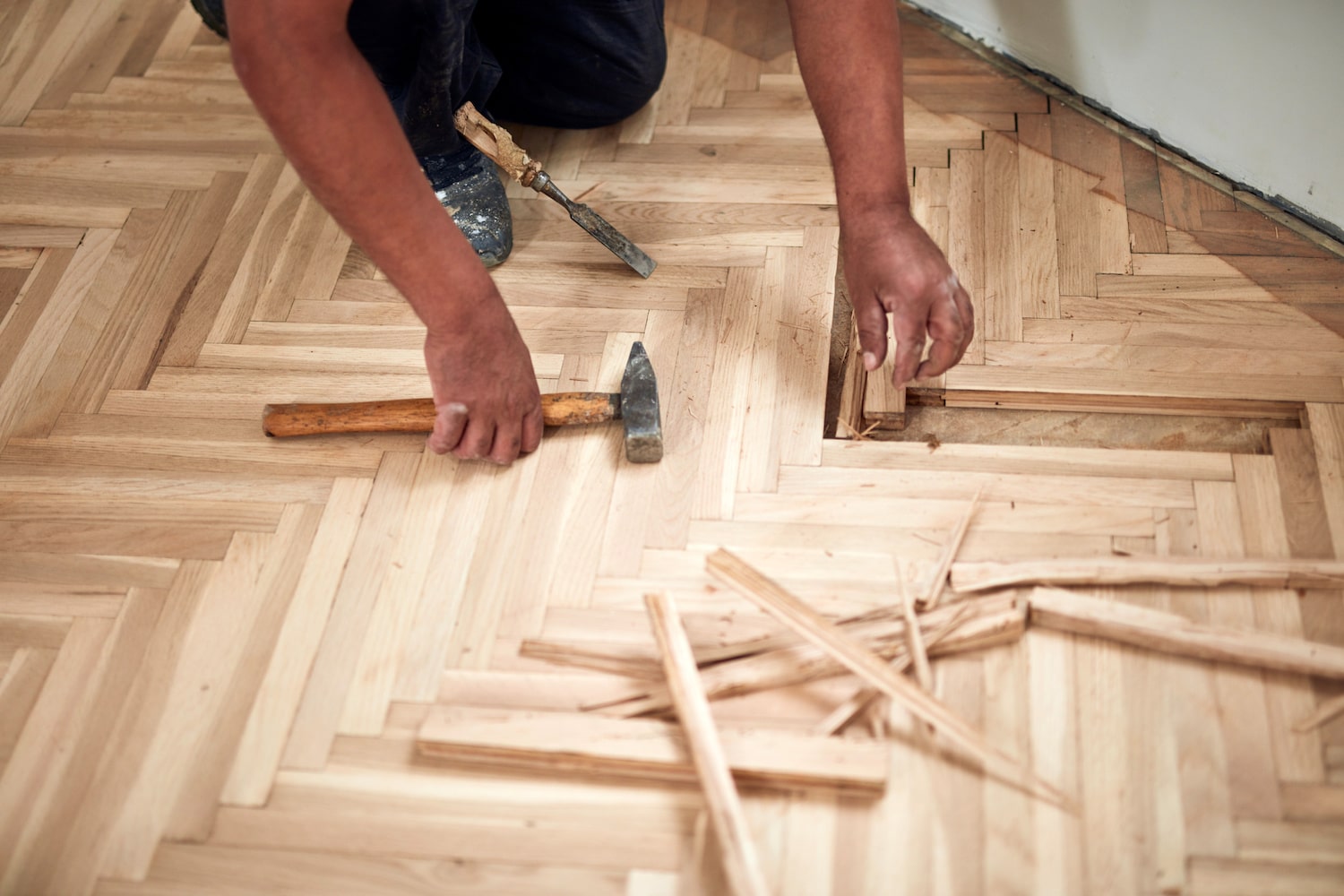 hardwood flooring cost man installing chevron hardwood flooring