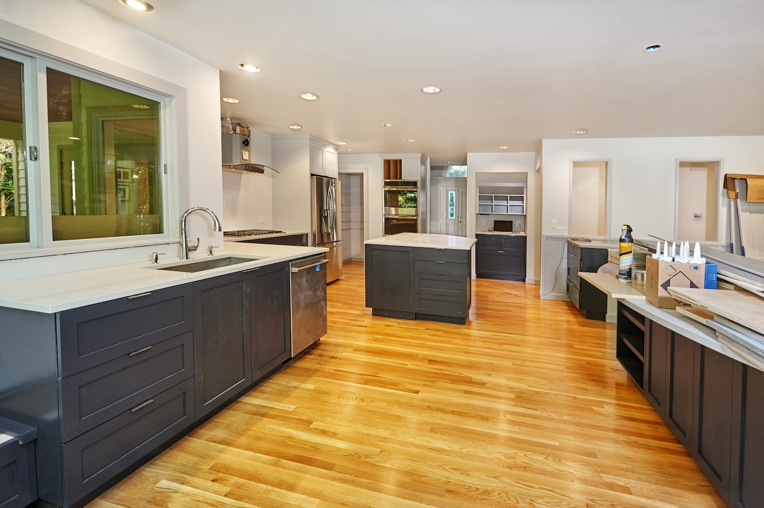 mixed hardwood flooring warm wood floors with dark blue monochrome kitchen cabinets