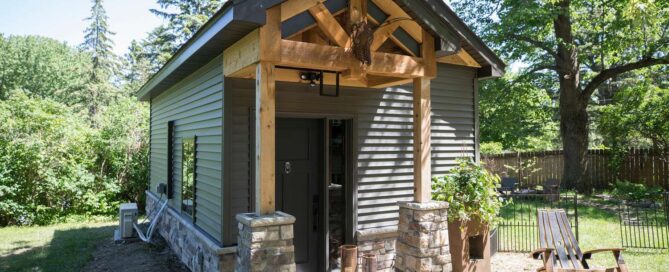 the entrance to the man cave which features reclaimed wood trusses and posts around the front door