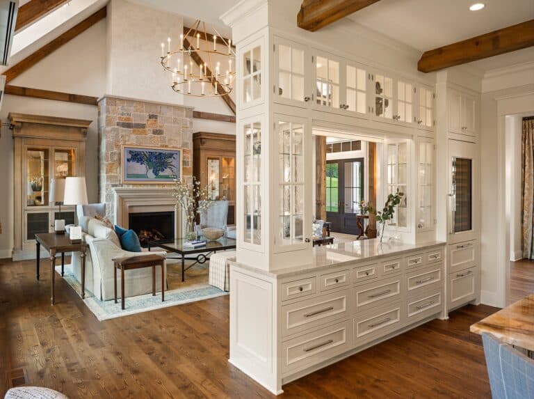 Transitional living room dining area with built-in separator and reclaimed wood decorative beams on ceiling