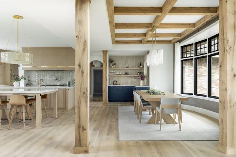 Modern open kitchen with reclaimed white oak decorative beam pillars separating dining area