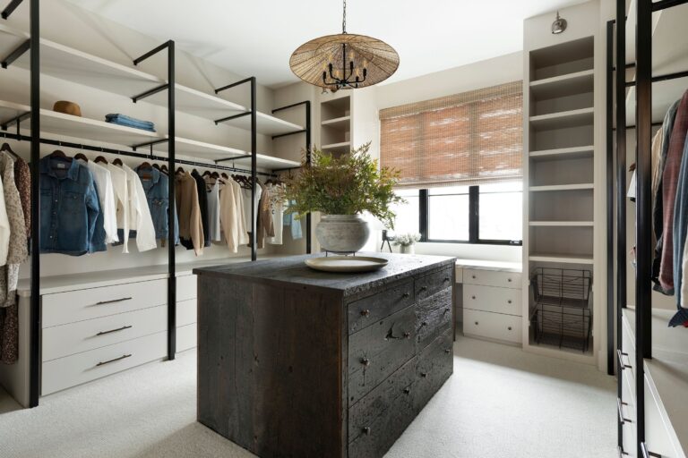 A modern walk in closet with a reclaimed wood drawer island made from weathered antique pine is a great reclaimed wood design.