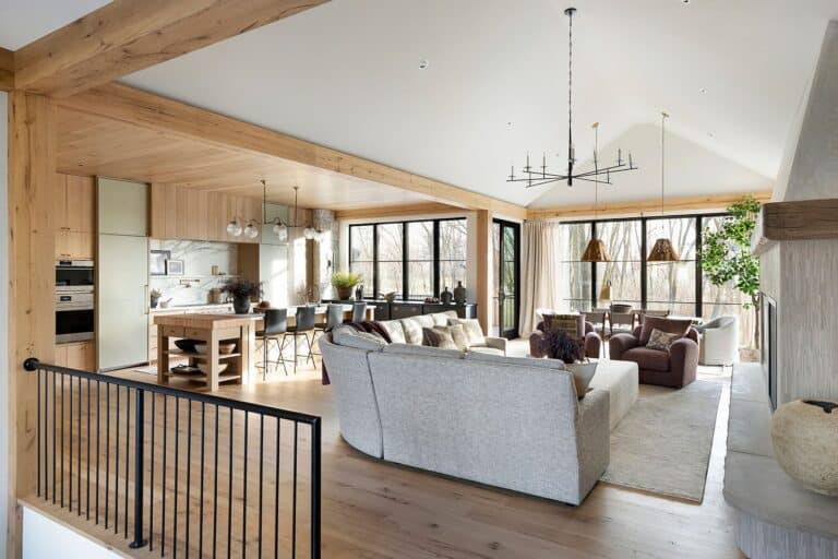 Open concept living room and kitchen with reclaimed white oak flooring and cabinets, natural light, vaulted ceilings, and modern fictures.