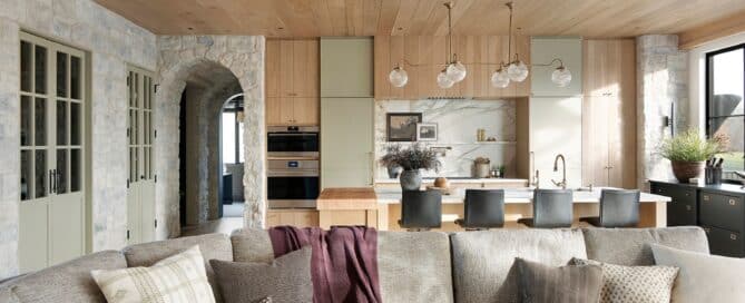 A modern open concept home from Tays and Co Design Studios with white oak reclaimed wood cabinets, box beams, and floors.