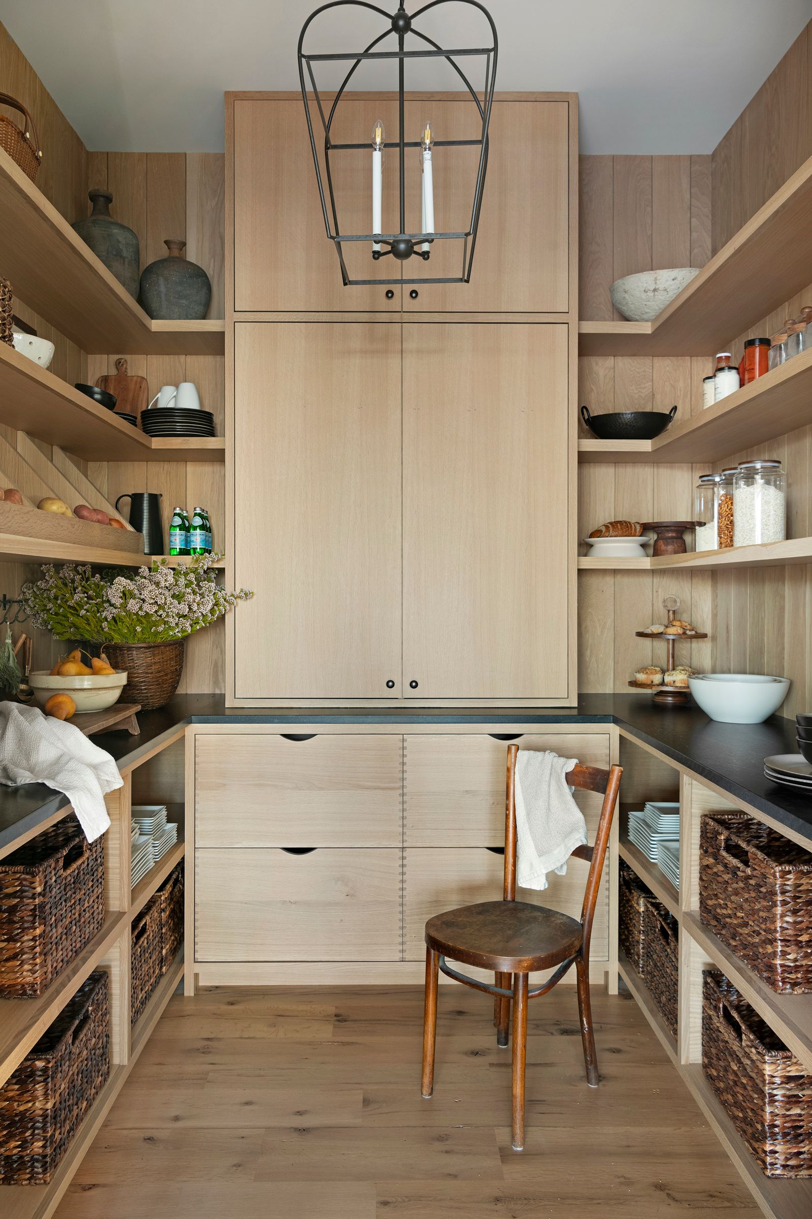 A walk-in pantry with custom cabinets made from white oak reclaimed wood is a fantastic reclaimed wood design.