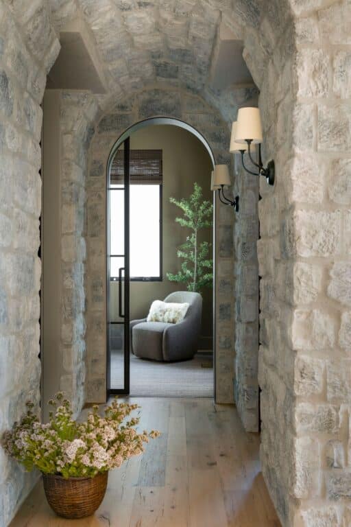 Barrel vaulted hallway with grey stone veneer. Reclaimed wood white oak floors.