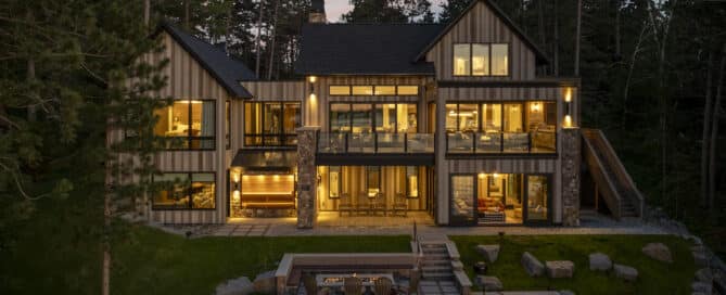 Luxury homes built by Nor-Son Custom Builders. Custom lake house with wood paneling and stone exteriors.