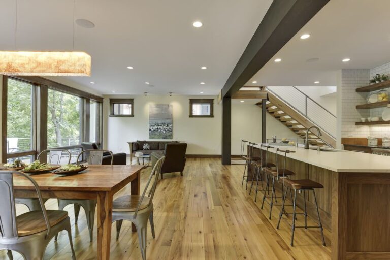 Open floor plan kitchen and dining space with elm reclaimed hardwood flooring.