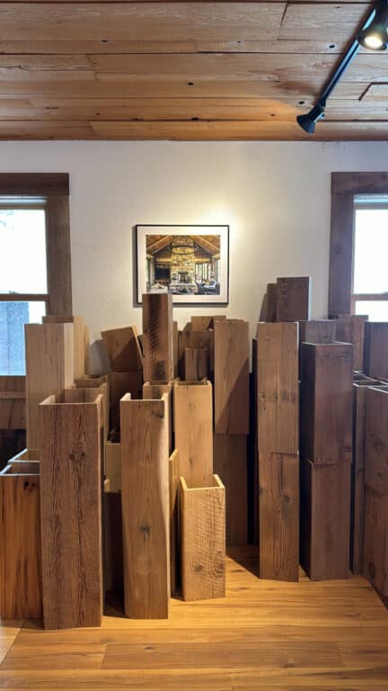 Reclaimed wood box beams standing on end in a show room. 