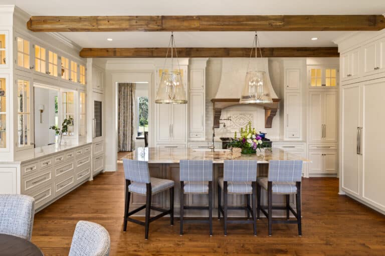 Milled original face reclaimed wood box beam ceiling beams above a kitchen and dining area. 