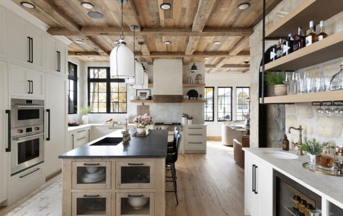 Bright custom kitchen with reclaimed white oak kitchen flooring and warm cabinetry
