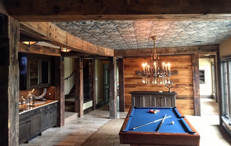 Game room with pool table, reclaimed wood timbers, and wormy chestnut wood accent wall.