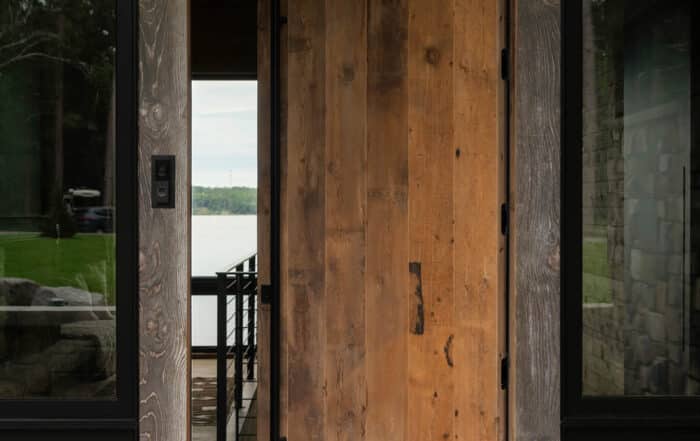 A reclaimed custom cut wood door opening to homes interior