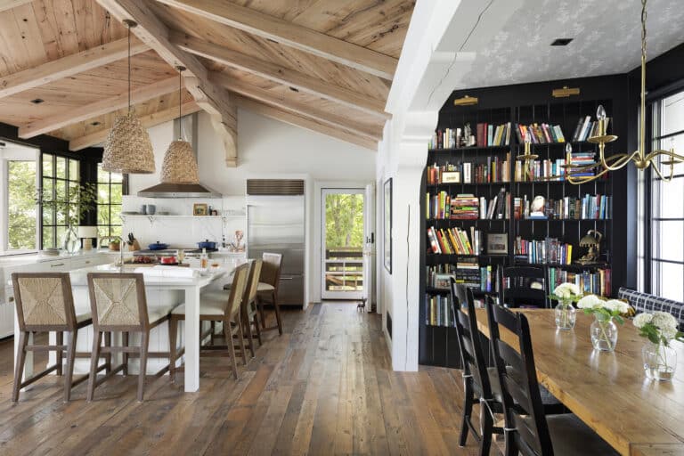Kitchen with vaulted ceiling, bookshelves, and weathered antique reclaimed wood flooring