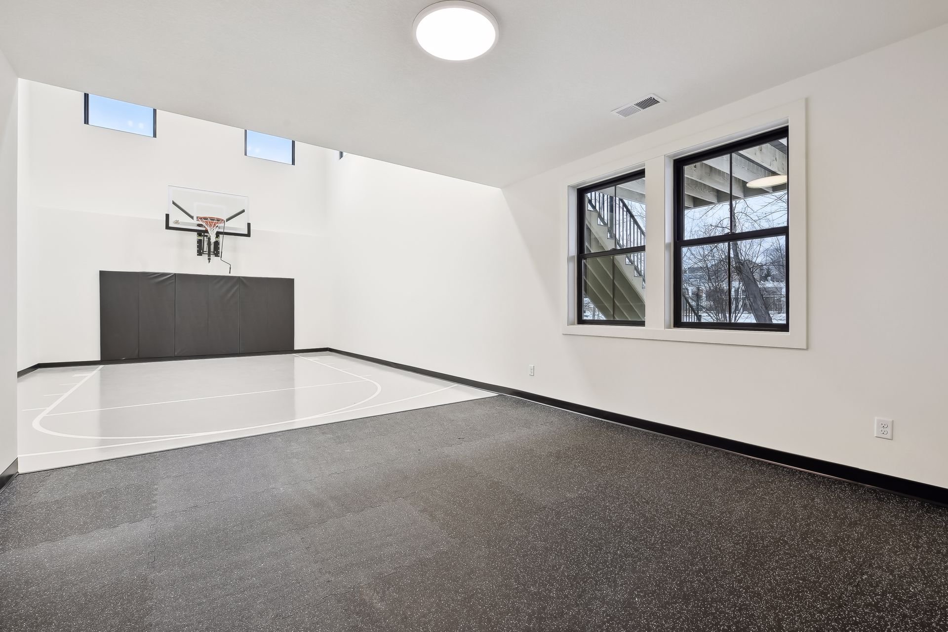 Custom half basketball court in Maple Grove luxury home from Minnesota home builders Zehnder Homes