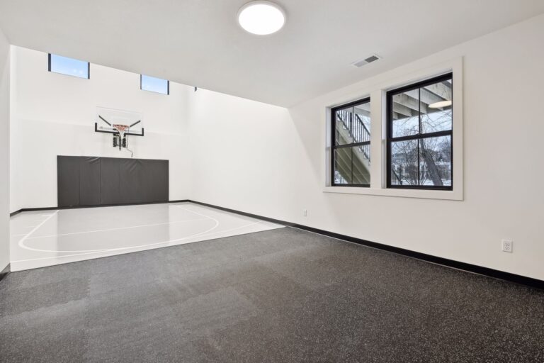 Custom half basketball court in Maple Grove luxury home from Minnesota home builders Zehnder Homes