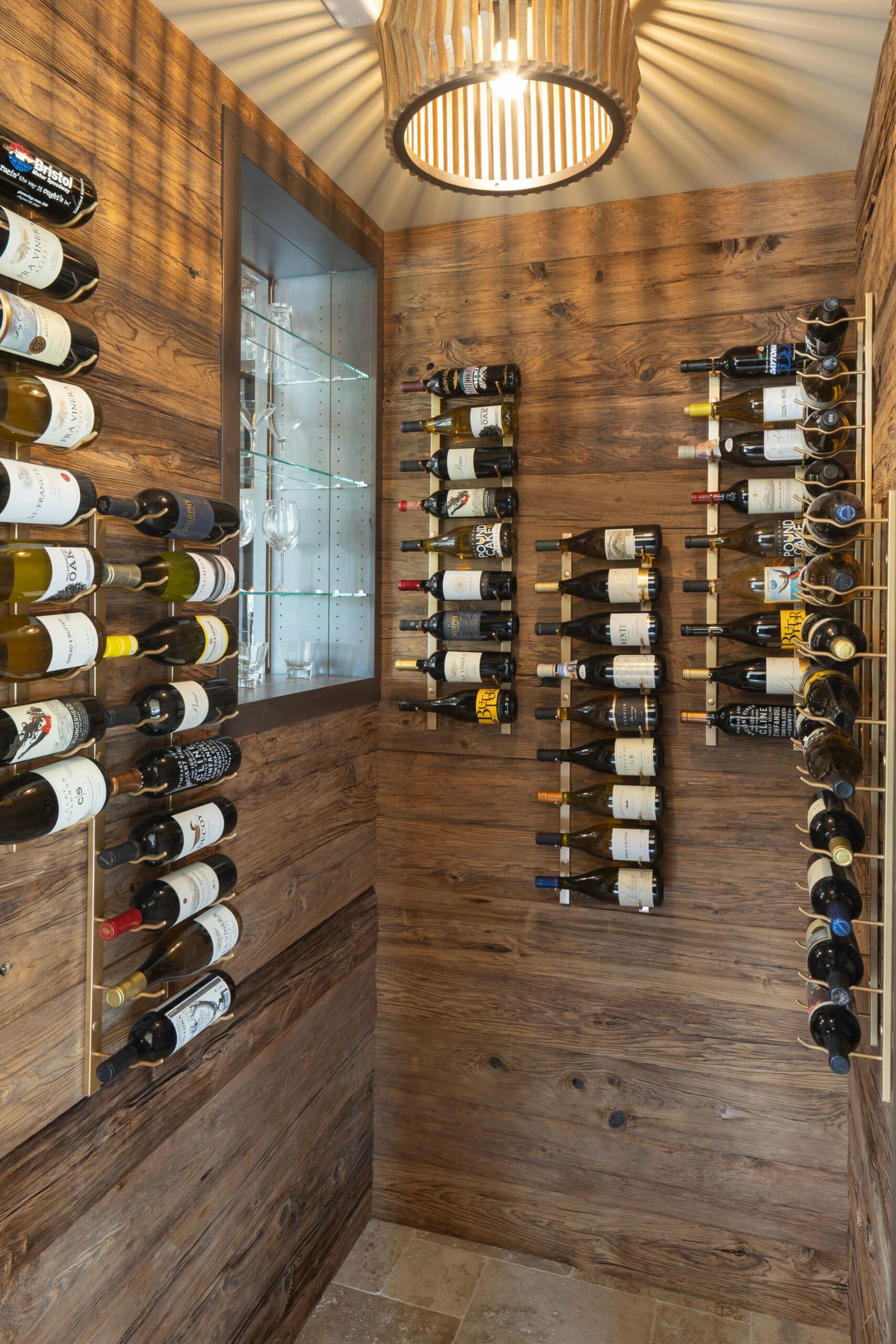 Custom wine cellar with bottles mounted on reclaimed mushroom wood paneling
