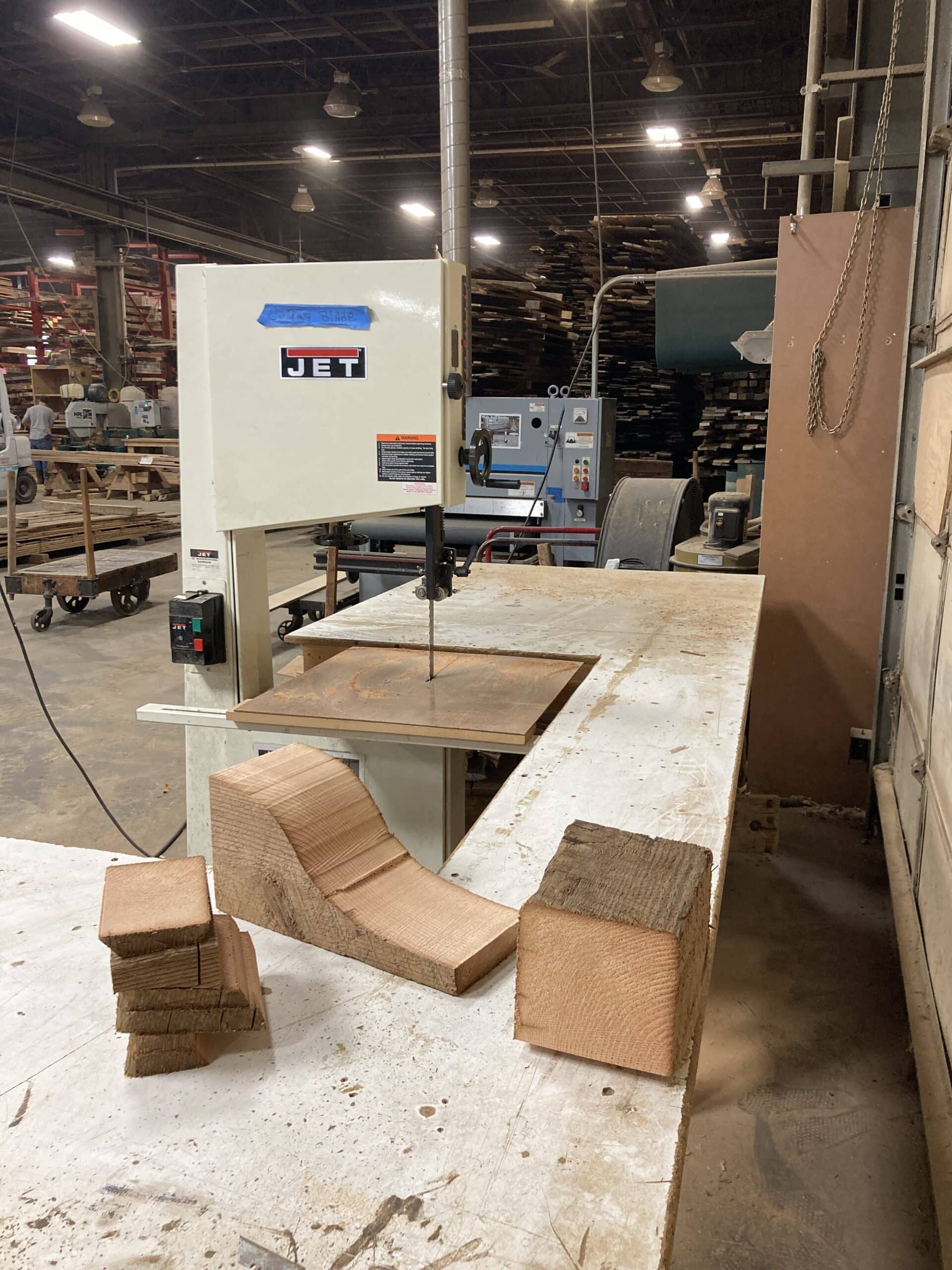 Wood milling band saw and pieces of cut wood