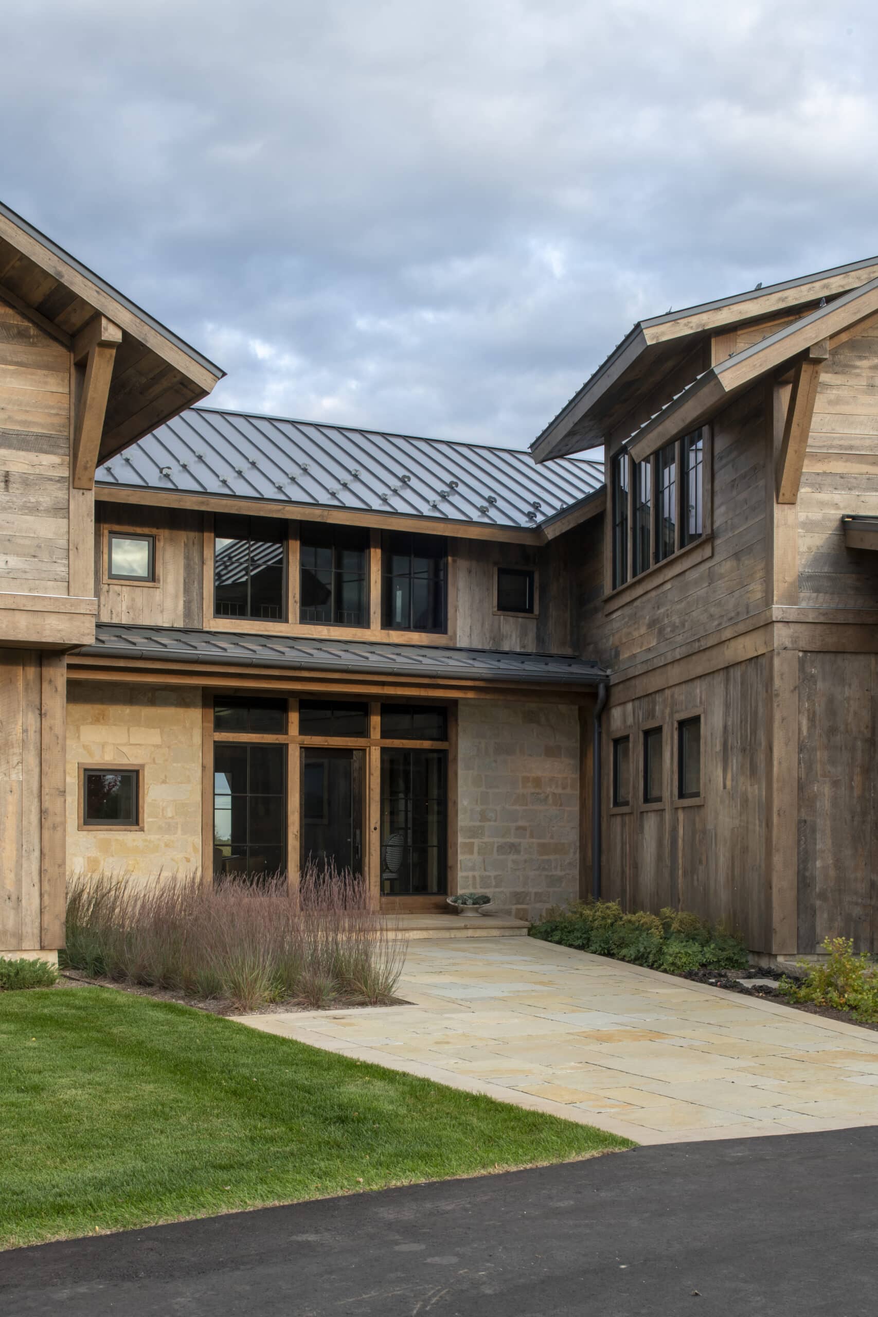 Modern home recessed entryway with reclaimed wood siding