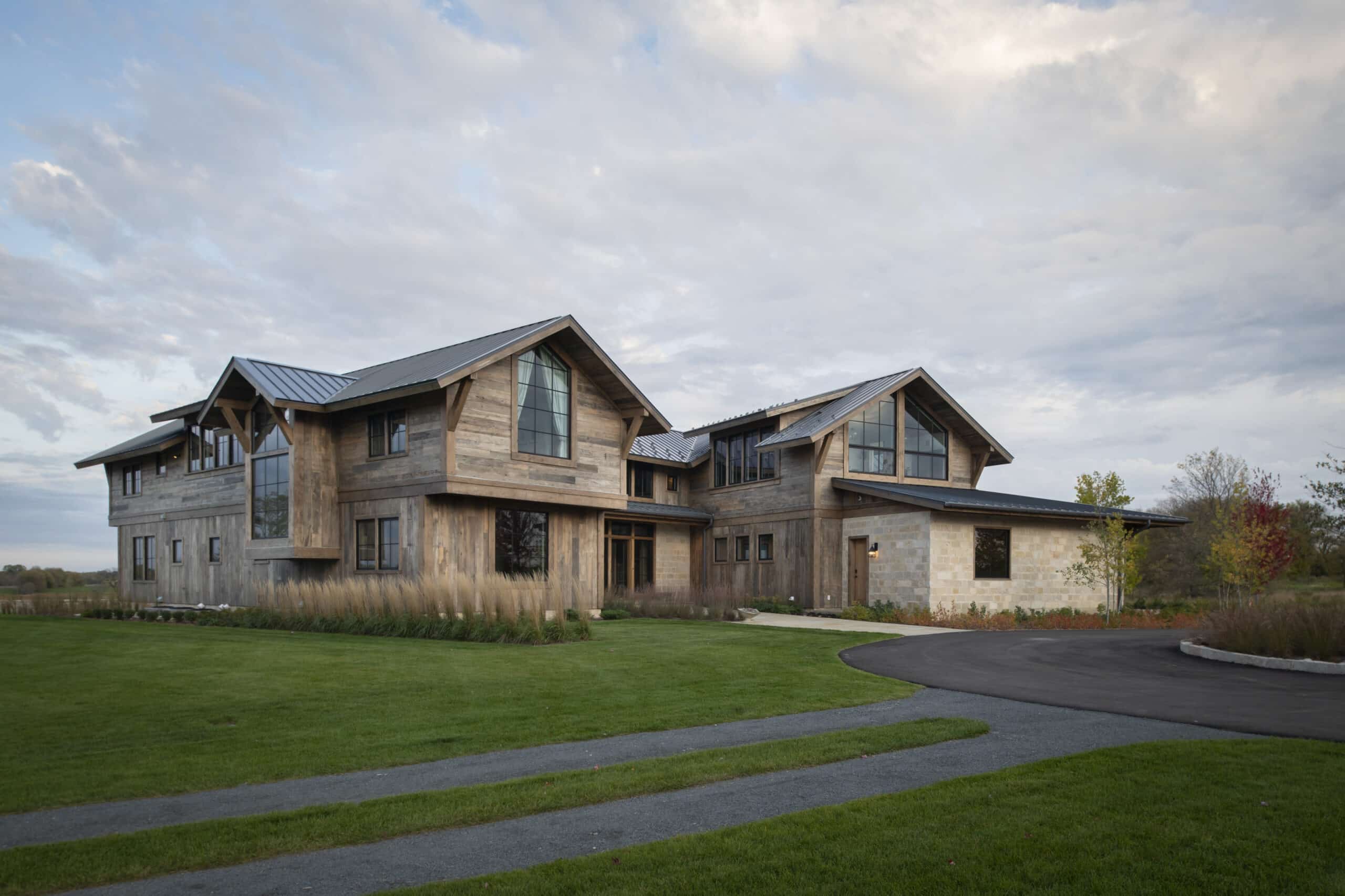 Back view of luxury minnesota prairie home with reclaimed wood siding