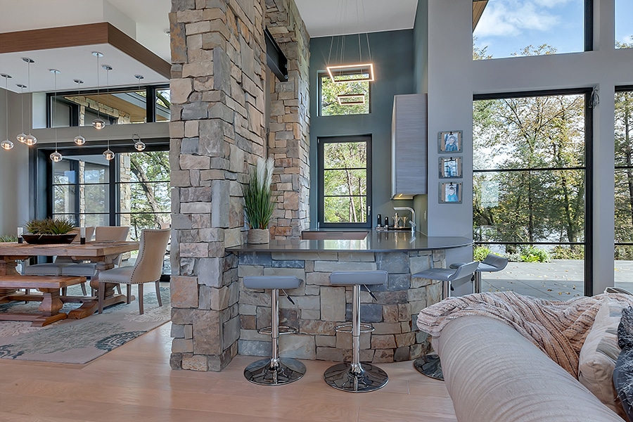 Bar and dining area with glass and stone from Minnesota custom home builder Werschay Homes
