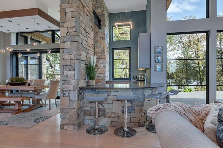 Bar and dining area with glass and stone from Minnesota custom home builder Werschay Homes