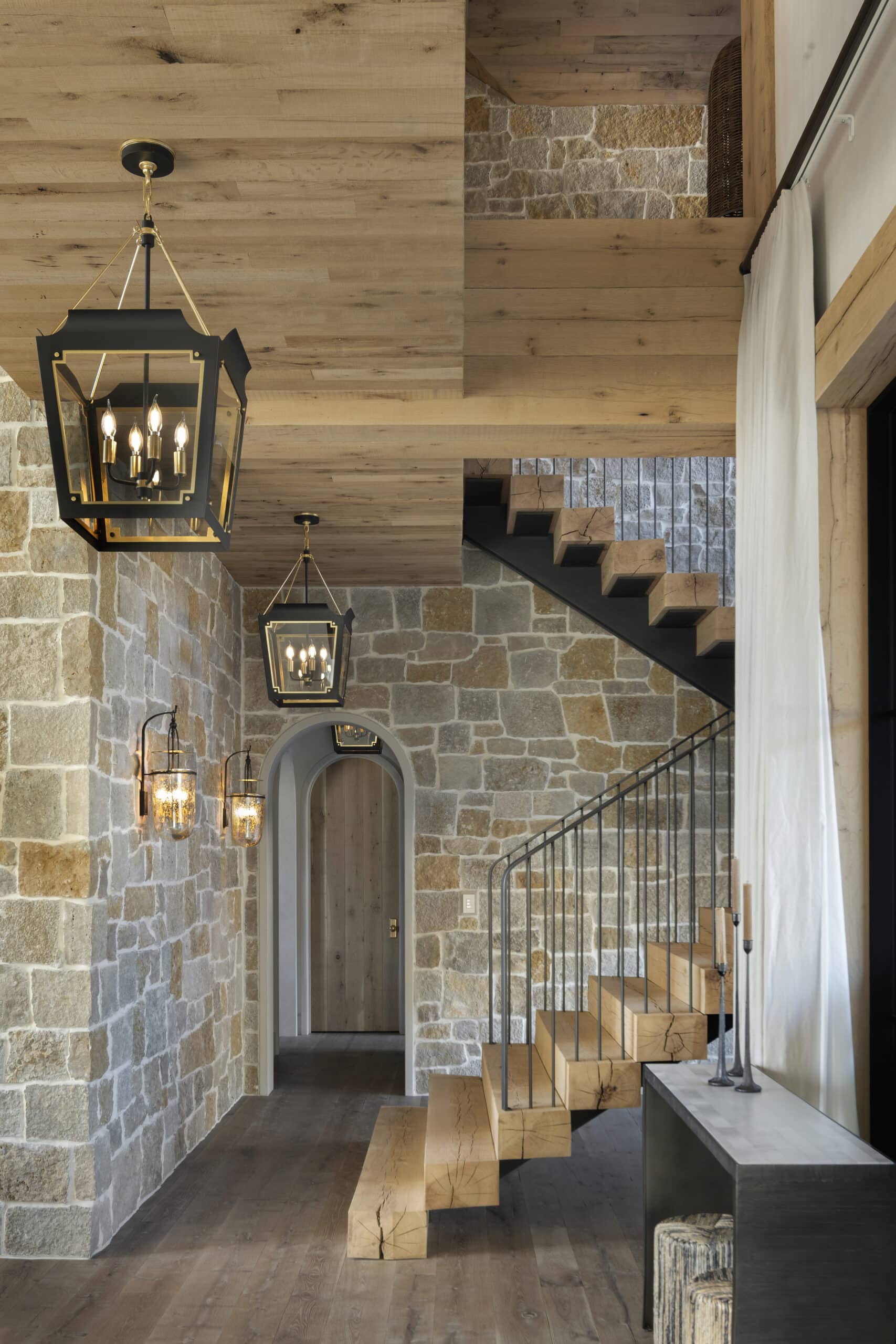 White oak reclaimed wood ceiling over staircase with stone walls