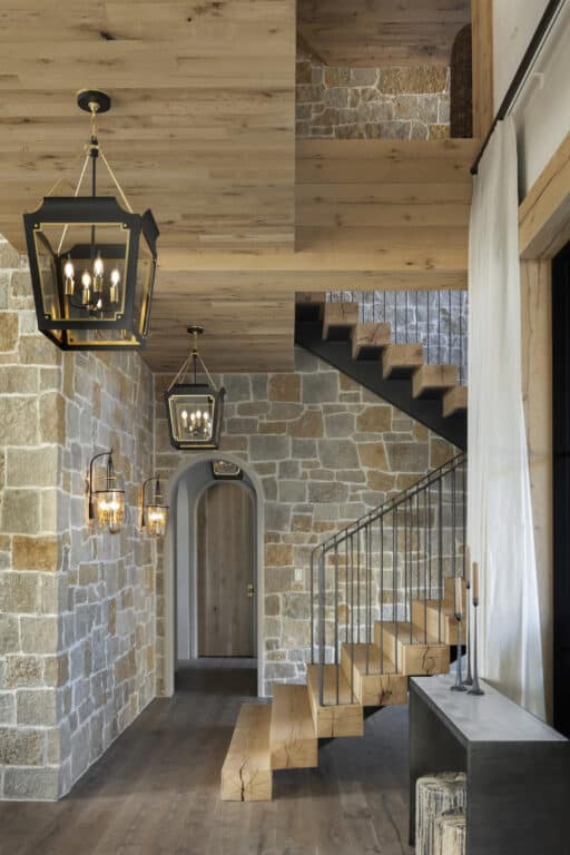 White oak reclaimed wood ceiling over staircase with stone walls