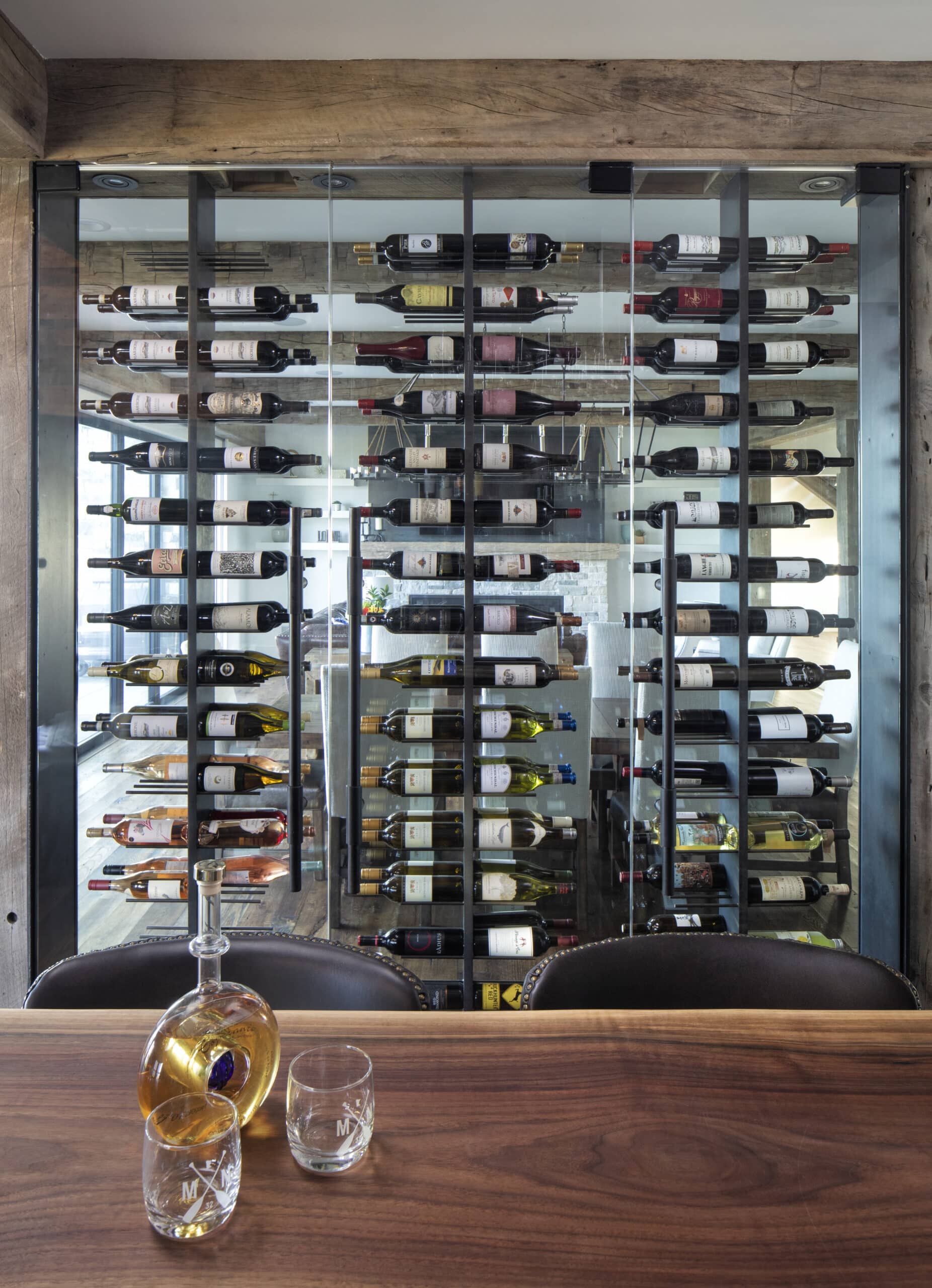 Glass door home wine cellar ideas with hand hewn timbers