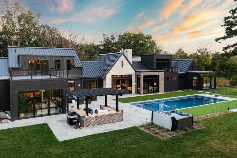Modern custom luxury home back yard with in ground pool and patio lounge area