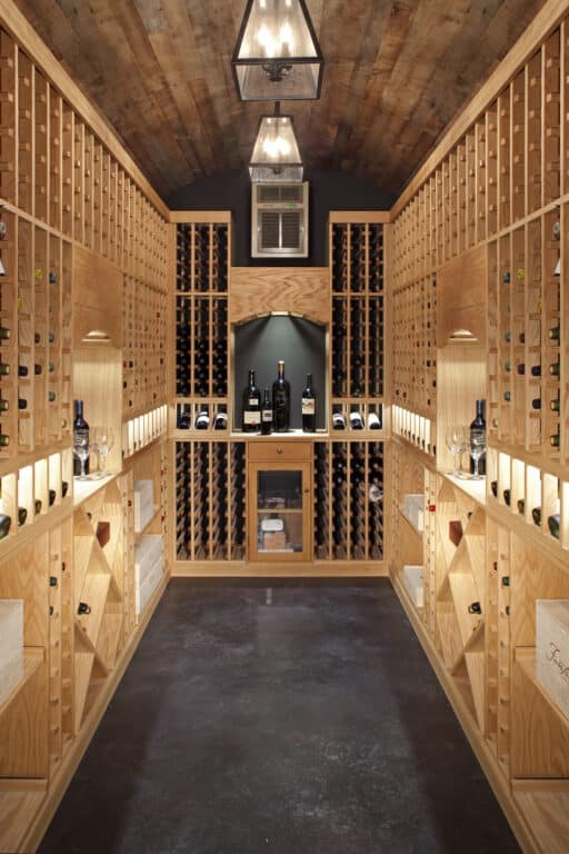 Walk-in home wine cellar with weathered antique barrel ceiling and floor to ceiling wood wine racks