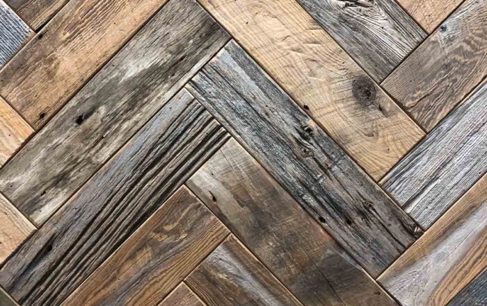 Close up of wood texture for weathered gray barnwood paneling in herringbone.