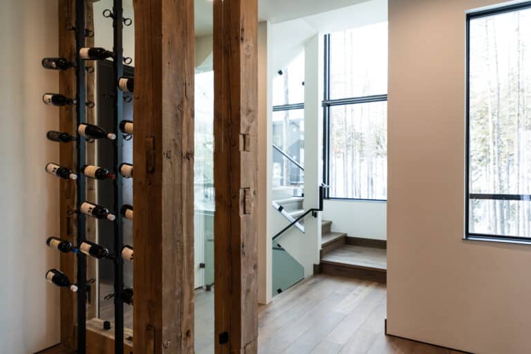 Modern wine cellar ideas with hand hewn timbers looking into stairwell
