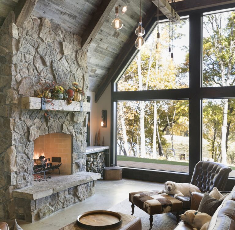 Hand Hewn timber fireplace mantel with iron straps in grand lodge room