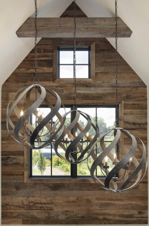 Wood panel accent wall window nook with hanging light fixture in front