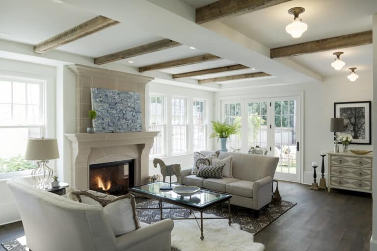 Bright and airy living room featuring a white wood ceiling with rustic box beams, offering elegant wood ceiling ideas. The exposed box beam design adds warmth and texture, perfectly blending modern and traditional aesthetics.